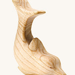 A beautifully hand crafted dolphin figure, showing the natural wood grain through out the toy