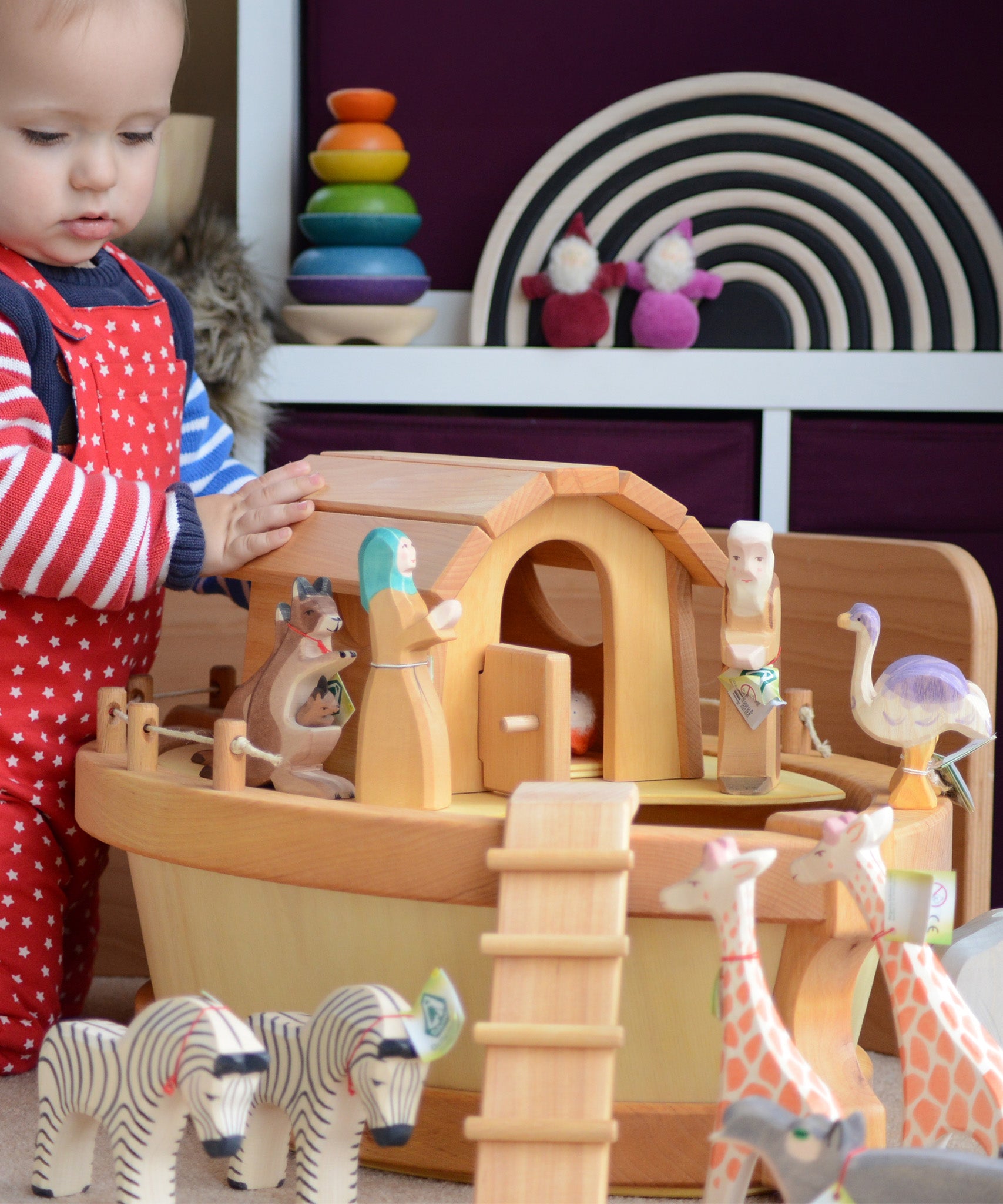 A child playing with the handmade wooden Ostheimer Noah's ark and ship's cabin with hand-painted animals and figures.