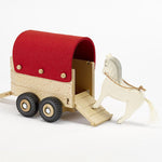 An Ostheimer horse toy getting ready to go inside the Ostheimer toy horsebox