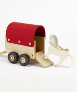 An Ostheimer horse toy getting ready to go inside the Ostheimer toy horsebox