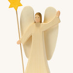 A wooden Ostheimer angel wearing a white gown holding a Ostheimer wooden star on a cream background