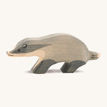 A wooden Ostheimer badger figure with its head straight on a cream background.