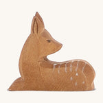 A wooden Ostheimer lying down on a cream background.