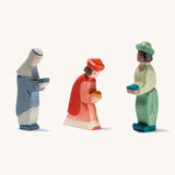3 wooden oriental Ostheimer figures standing next to each other on a cream background.