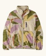 Patagonia women's synchilla fleece jacket in cream with a repeating abstract pattern. Shows a front zip, side and chest pocket