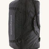 The Patagonia Black Hole Duffel 100L Black upright showing the shoulder straps and carry handles