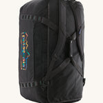 The Patagonia Black Hole Duffel 100L Ink Black upright showing the shoulder straps and carry handle