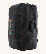 The Patagonia Black Hole Duffel 100L Ink Black upright showing the shoulder straps and carry handle