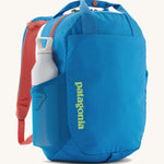 Patagonia® Atom Tote Pack 20L showing a water bottle in the mesh side sleeve