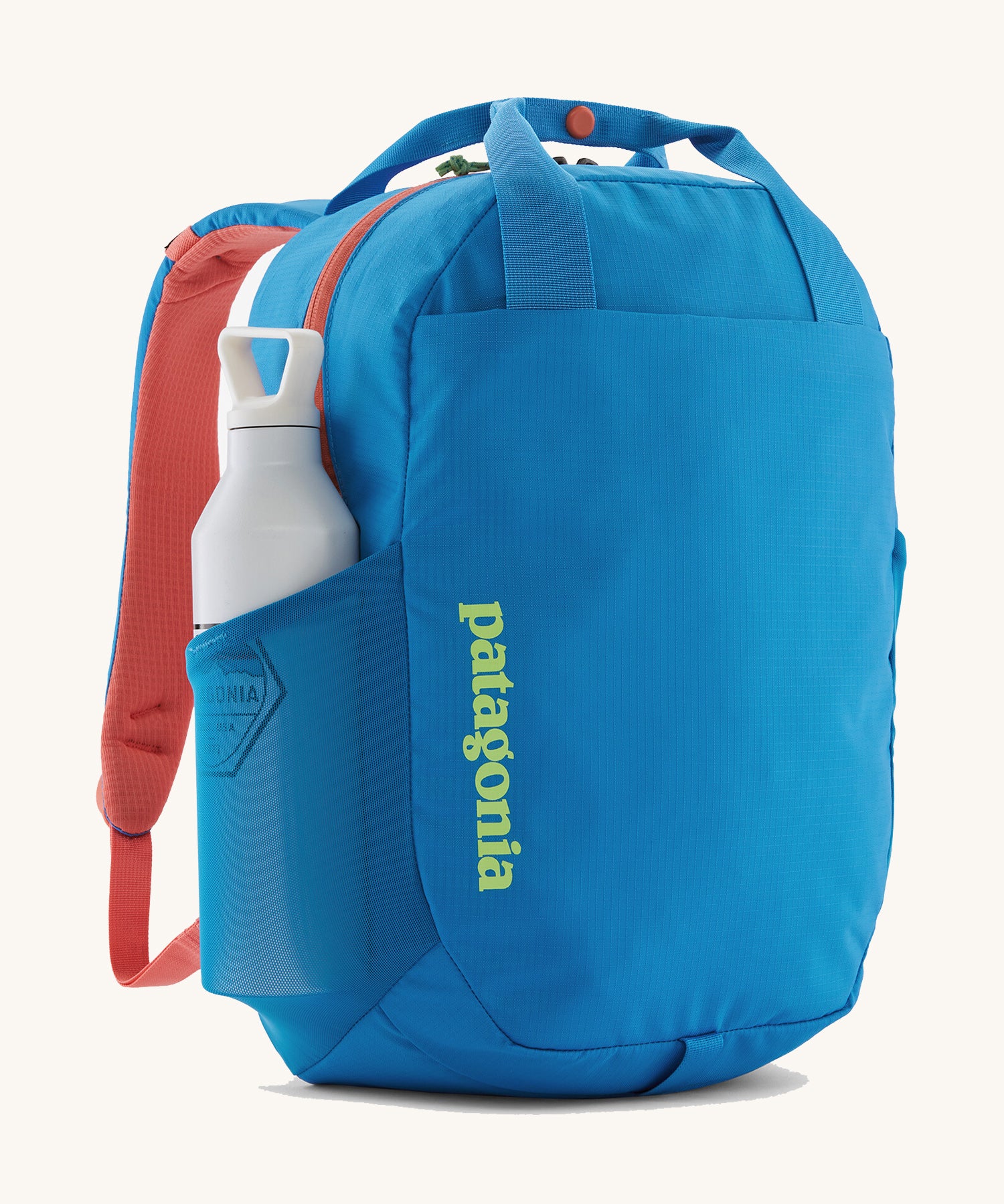 Patagonia® Atom Tote Pack 20L showing a water bottle in the mesh side sleeve