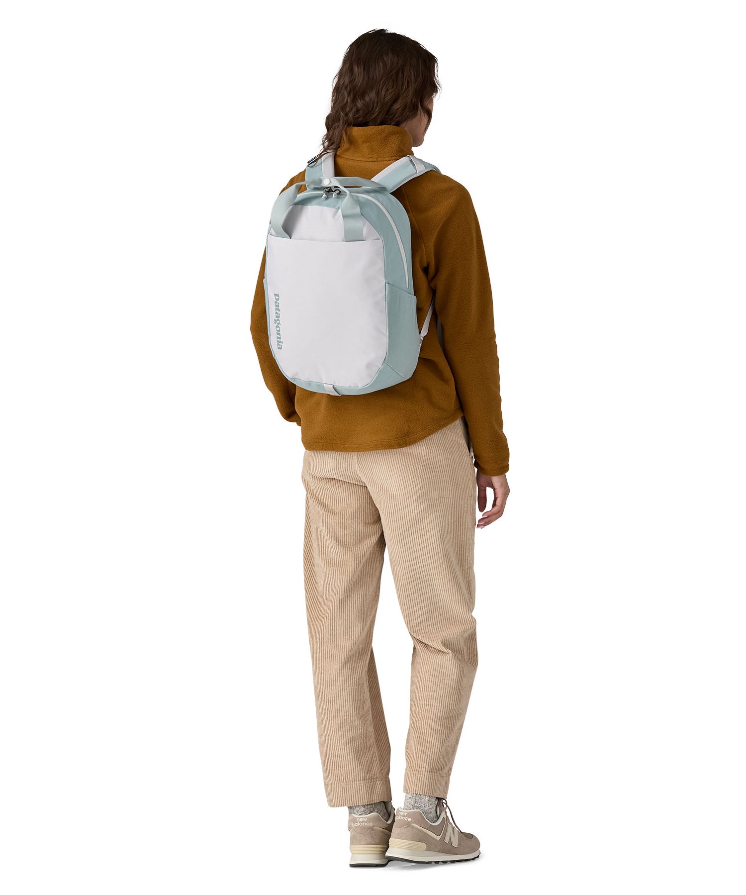 A person wearing the Patagonia Atom Tote Pack 20L Crisp Grey on their back