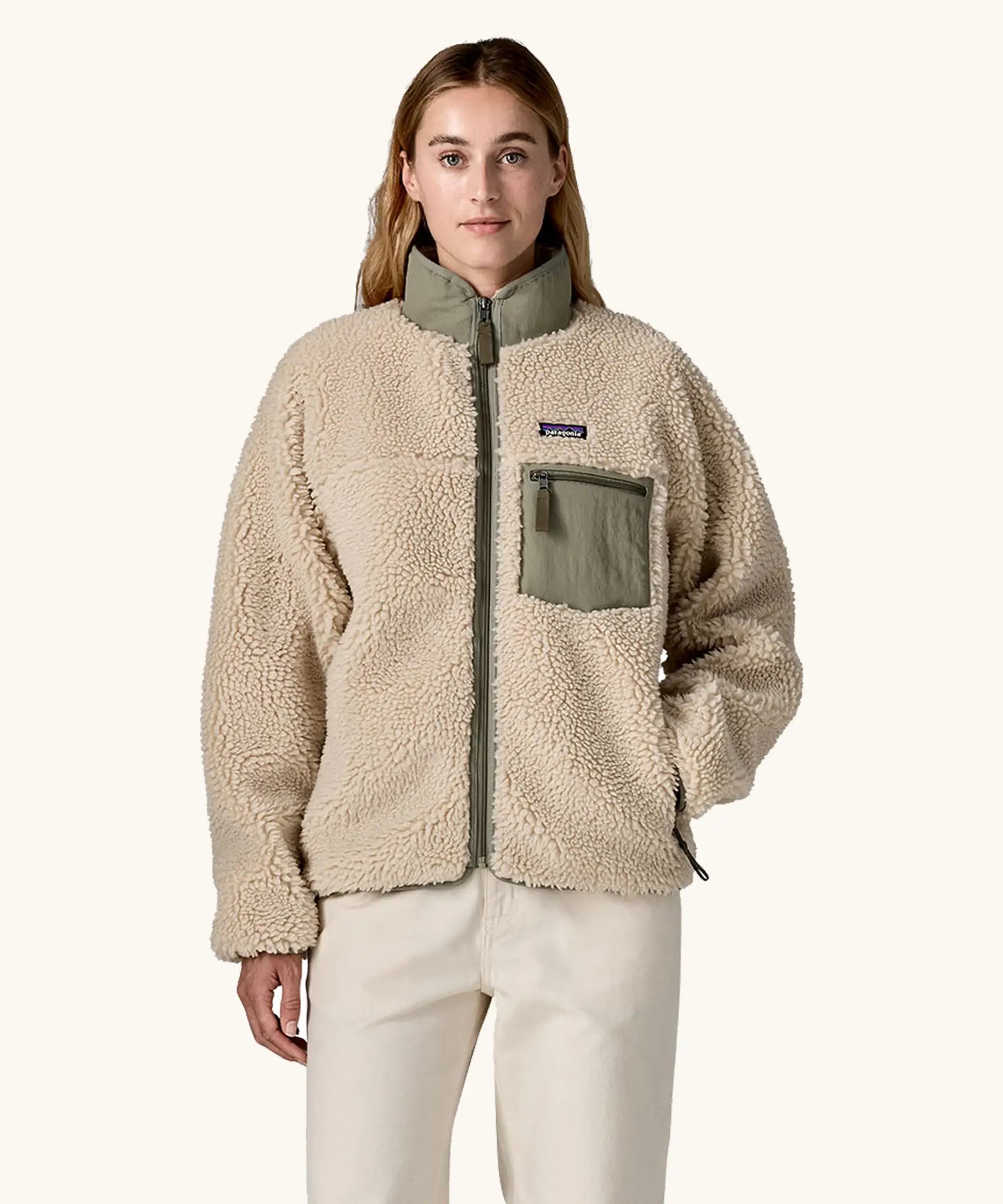 Woman wearing Patagonia Women's Classic Retro-X® Fleece Jacket in Dark Natural w/River Rock Green. Fully zipped. 