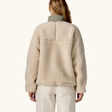 Back of woman wearing Patagonia Women's Classic Retro-X® Fleece Jacket in Dark Natural w/River Rock Green.
