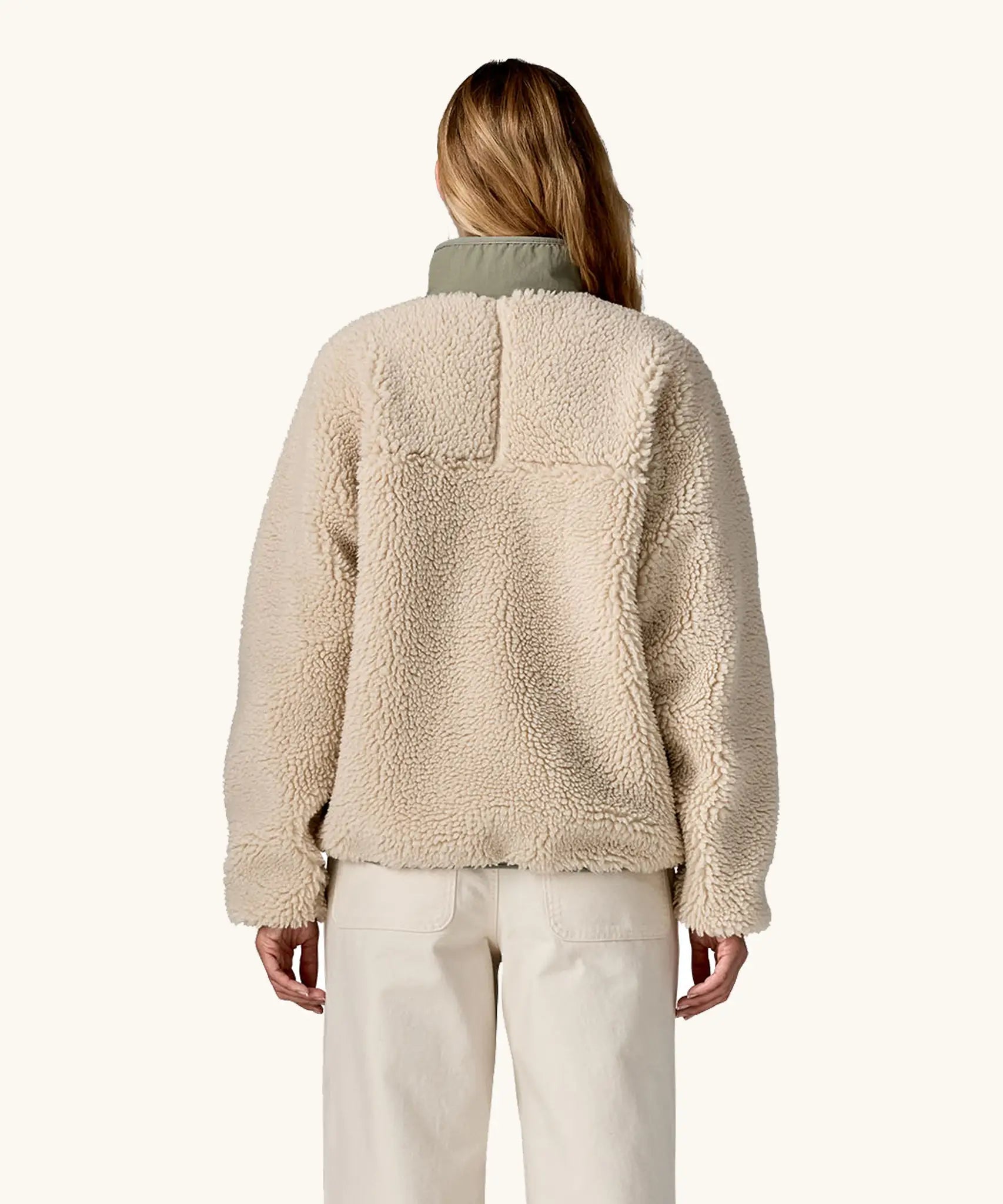 Back of woman wearing Patagonia Women's Classic Retro-X® Fleece Jacket in Dark Natural w/River Rock Green.