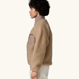 Side view of woman wearing Patagonia Women's Classic Retro-X® Fleece Jacket in oar tan.