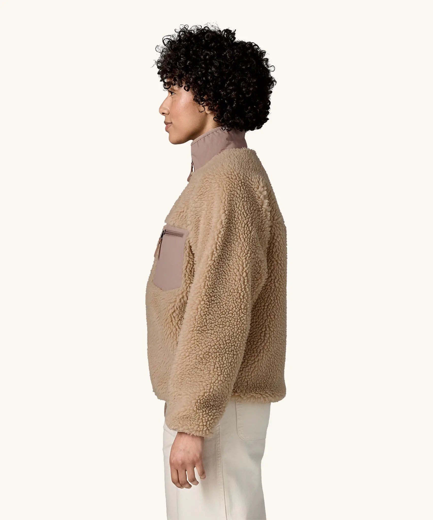 Side view of woman wearing Patagonia Women's Classic Retro-X® Fleece Jacket in oar tan.