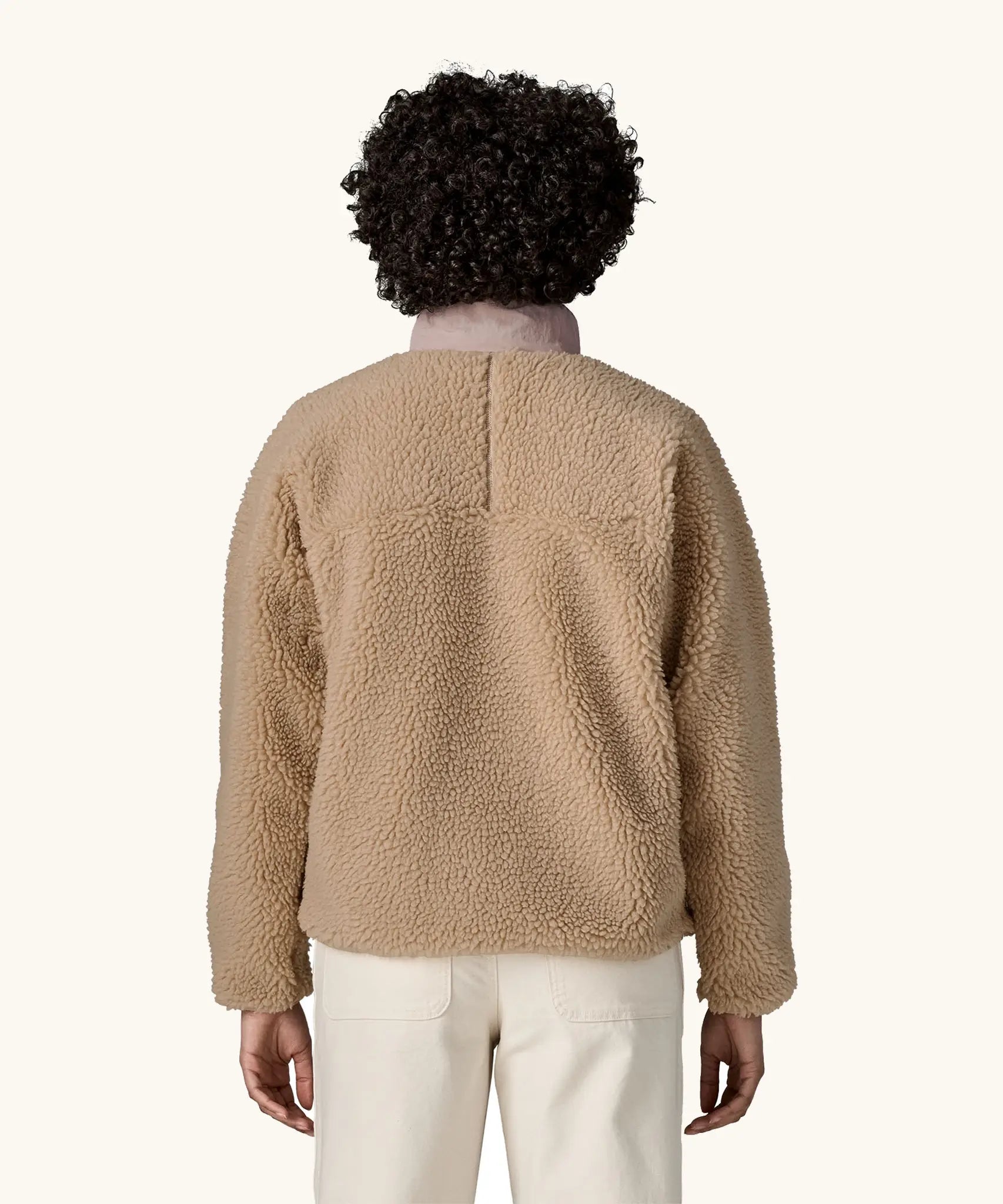 Back of woman wearing Patagonia Women's Classic Retro-X® Fleece Jacket in oar tan.