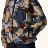 Close up of Woman wearing Patagonia Women's Classic Retro-X® Fleece Jacket in Smudge, Smolder Blue. Hand in pocket. 