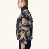 Side view of Woman wearing Patagonia Women's Classic Retro-X® Fleece Jacket in Smudge, Smolder Blue.