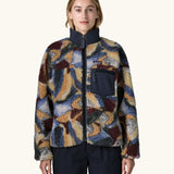 Woman wearing Patagonia Women's Classic Retro-X® Fleece Jacket in Smudge, Smolder Blue. Turn up collar, full length zip, 2 side handwarmer pockets and an easy access chest pocket. 