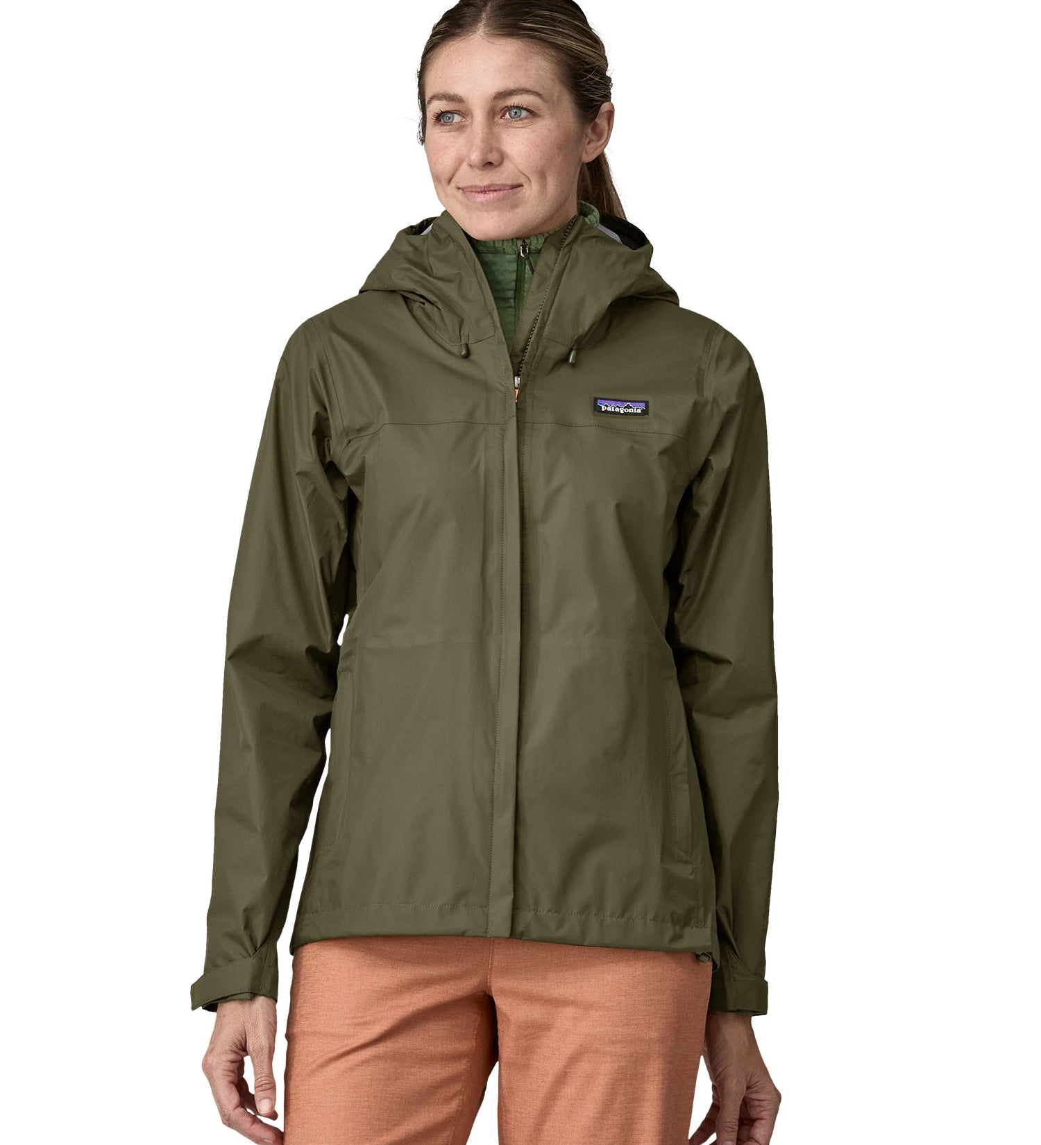 A person wearing the Patagonia Women's Torrentshell 3L Rain Jacket - Pine Needle Green, to show the fit of the jacket from the front.