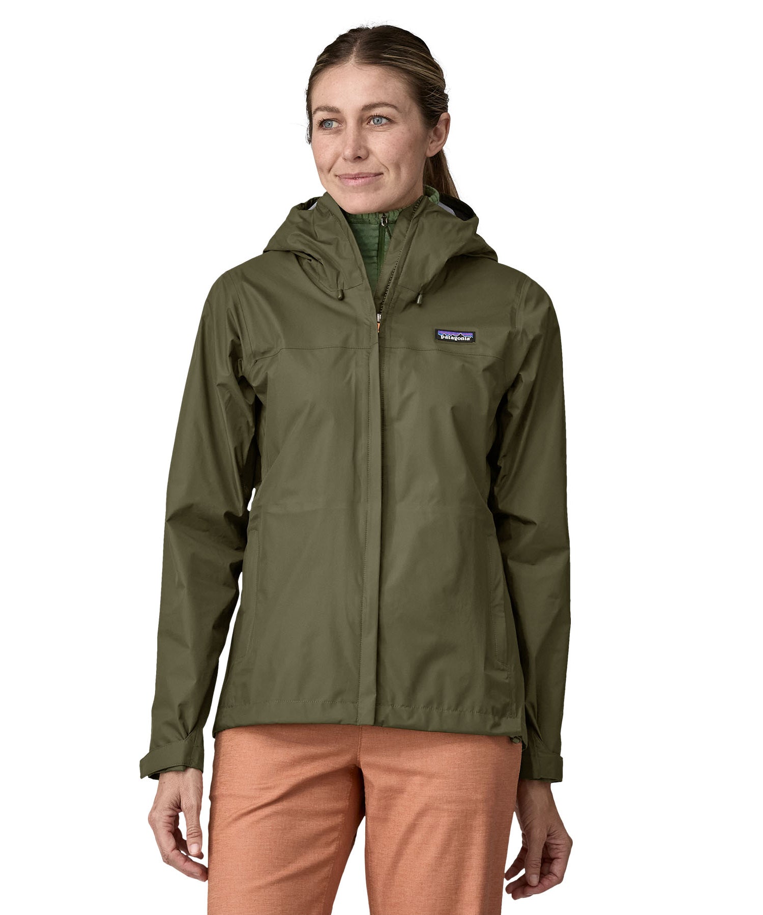 A person wearing the Patagonia Women's Torrentshell 3L Rain Jacket - Pine Needle Green, to show the fit of the jacket from the front.