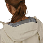 A closer view of the hood on the Patagonia Women's Torrentshell 3L Rain Jacket. The image also shows a person from the back with their hair tied up