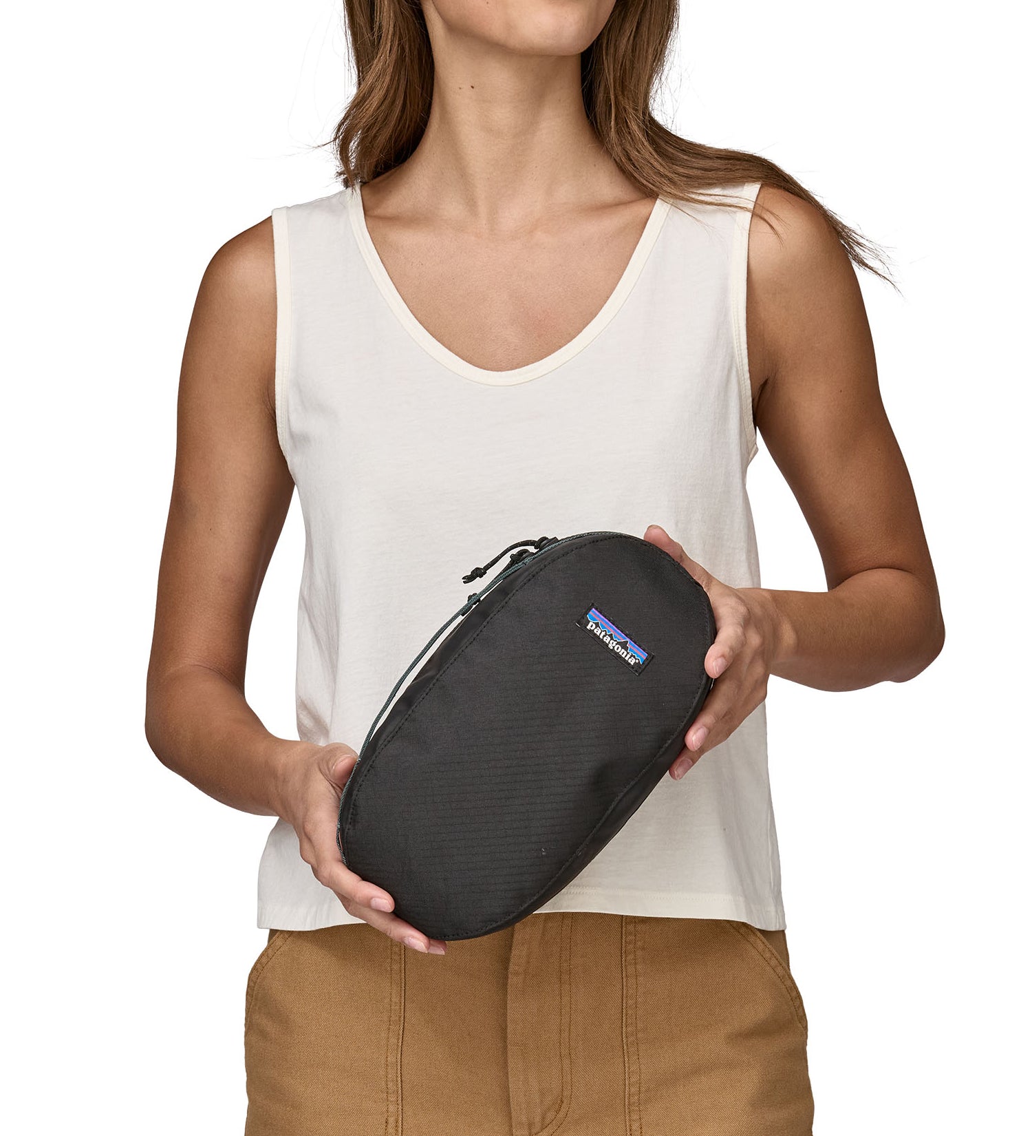 A person holding a Patagonia Black Hole Cube 3L in their hands
