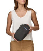 A person holding a Patagonia Black Hole Cube 3L in their hands