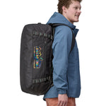 A person wearing the Patagonia Black Hole Duffel 55L Ink Black on the back