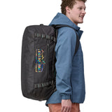 A person wearing the Patagonia Black Hole Duffel 55L Ink Black on the back