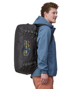 A person wearing the Patagonia Black Hole Duffel 55L Ink Black on the back