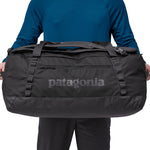 A person holding the Patagonia Black Hole Duffel 70L Black to show the size