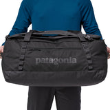 A person holding the Patagonia Black Hole Duffel 70L Black to show the size