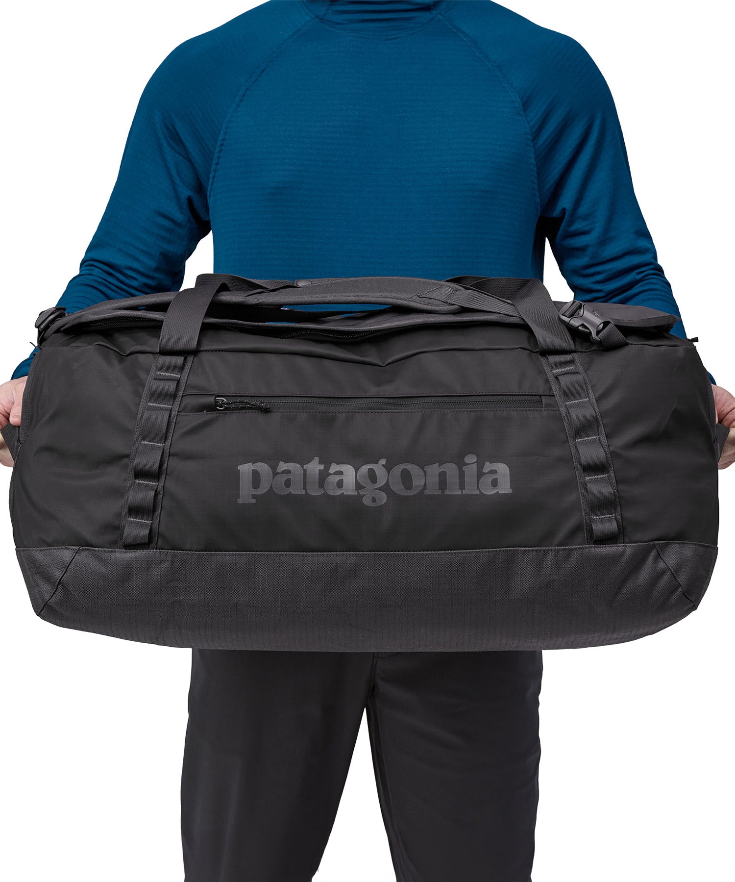 A person holding the Patagonia Black Hole Duffel 70L Black to show the size
