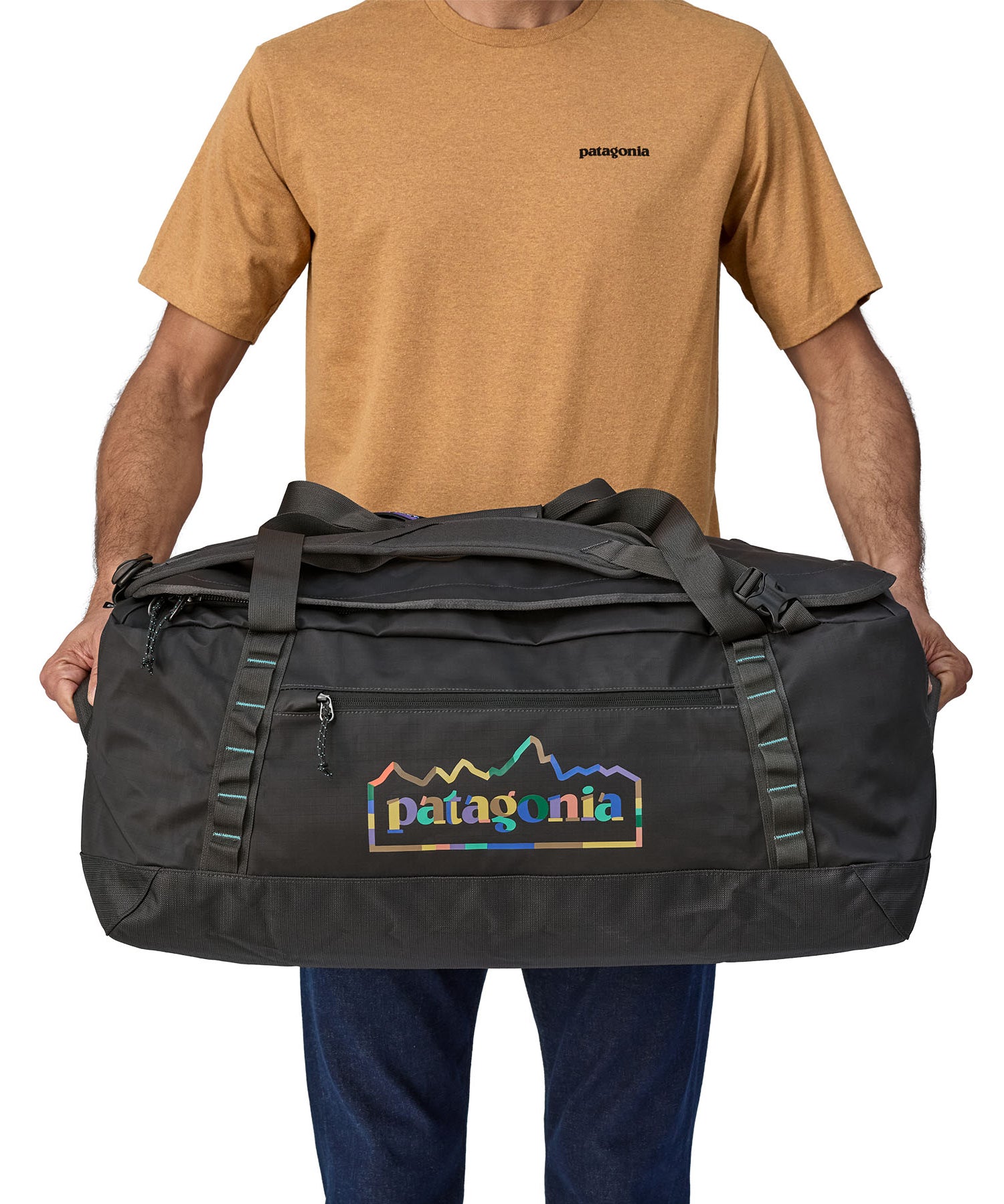A person holding the Patagonia Black Hole Duffel 70L Ink Black in their hands to show the size