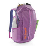 Patagonia black hole 25 litre backpack in brisk purple available at Babipur showing the mesh side pocket holding a water bottle 
