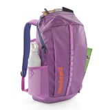 Patagonia black hole 25 litre backpack in brisk purple available at Babipur showing the mesh side pocket holding a water bottle 