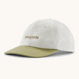 Patagonia organic cotton fitz roy icon trad cap in white with dark green visor and brand text on the front. 