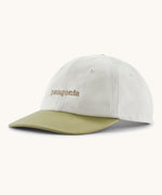 Patagonia organic cotton fitz roy icon trad cap in white with dark green visor and brand text on the front. 