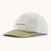 Patagonia organic cotton fitz roy icon trad cap in white with dark green visor and brand text on the front. 