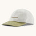 Patagonia organic cotton fitz roy trad cap in white with dark green visor and brand text on the front. 