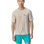 A person wearing light blue shorts, is wearing the Patagonia Men's Cap Cool Trail Graphic T-Shirt to show the fit from the front