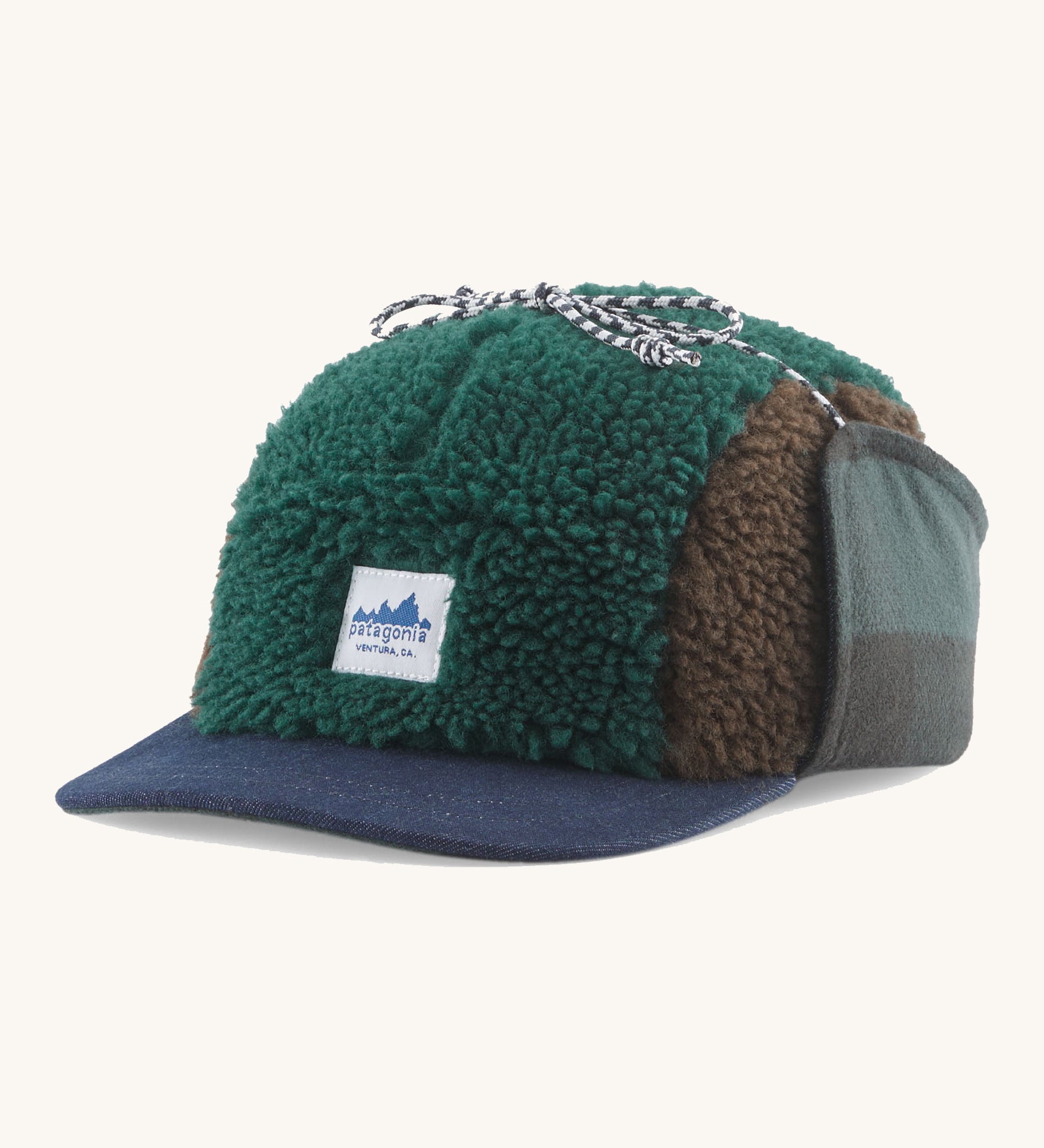 Patagonia Adult Unisex Range Earflap Cap with cascade green and brown fleece and a white logo tag on the front with a denim trim, for sale at Babipur.