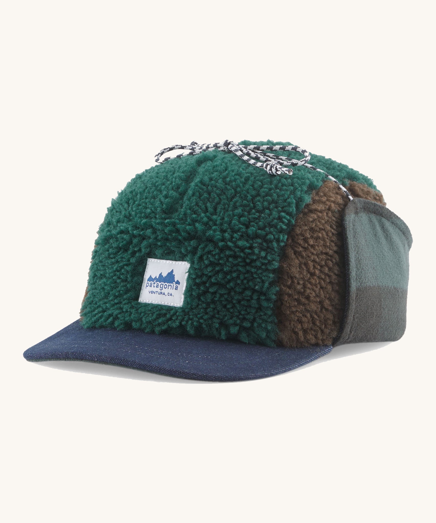 Patagonia Adult Unisex Range Earflap Cap with cascade green and brown fleece and a white logo tag on the front with a denim trim, for sale at Babipur.