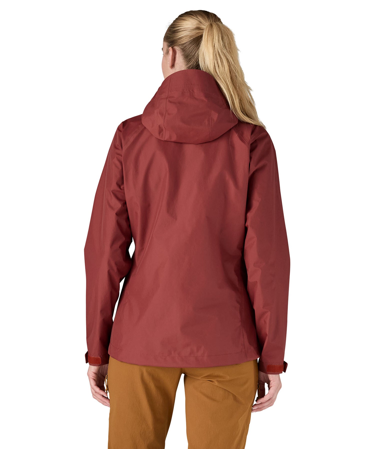 The back of the Patagonia Women's Torrentshell 3L Rain Jacket - Oxide Red. The image shows a person wearing the jacket to show the fit of the coat from the back and the hood