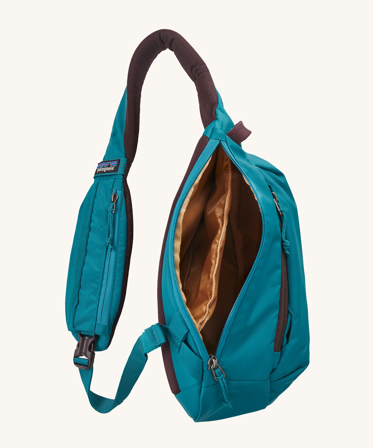 The Patagonia Atom Sling 8L open and showing the inside compartments
