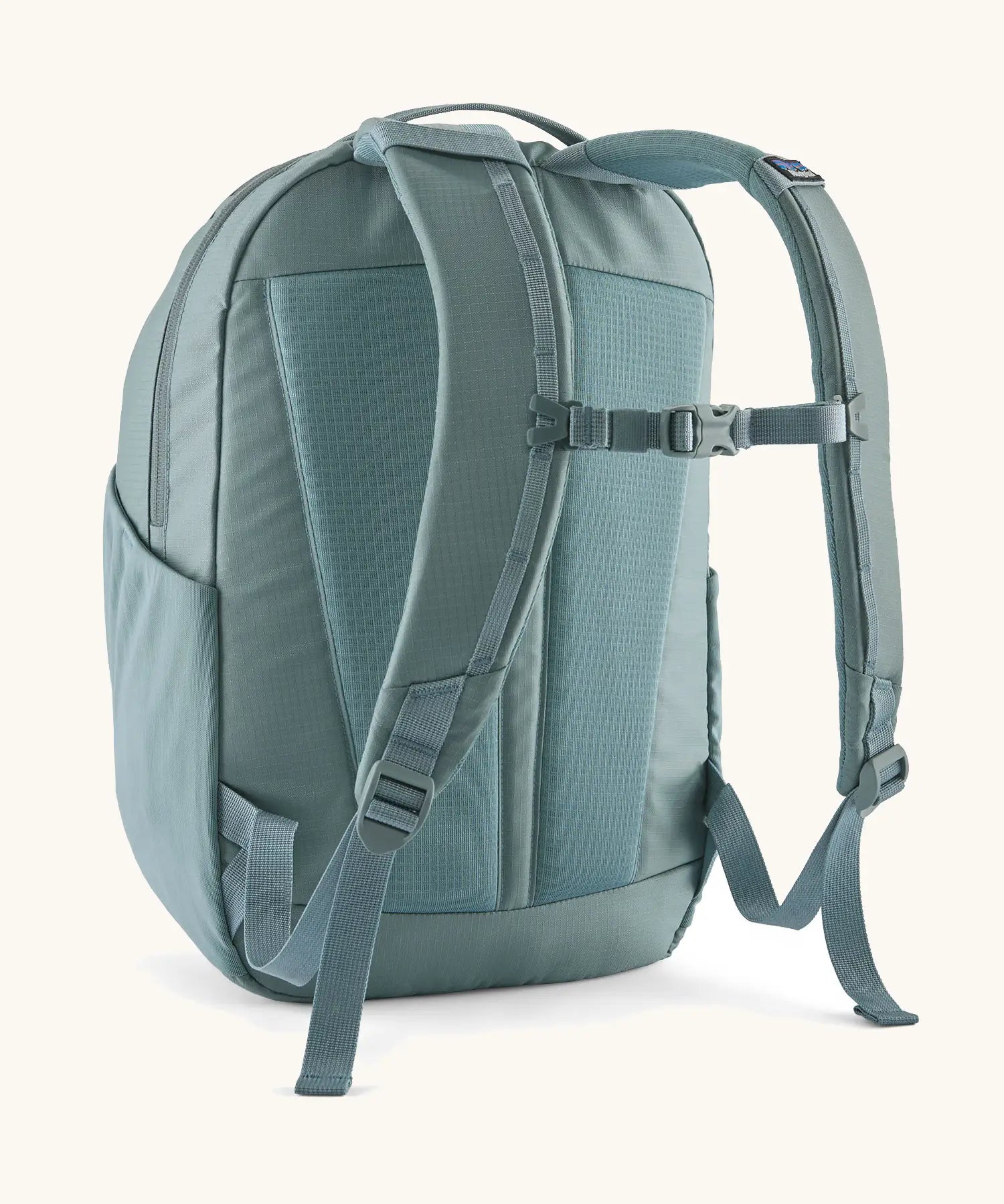 Patagonia atom 24 litre day pack in sage blue with matching shoulder straps and quick release buckle 