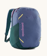 Patagonia atom 24 litres day pack in current blue. A 100% recycled material backpack in blue with dark green, pink and yellow detail. Features padded shoulder pads, mesh side pockets and 2 main compartments. 