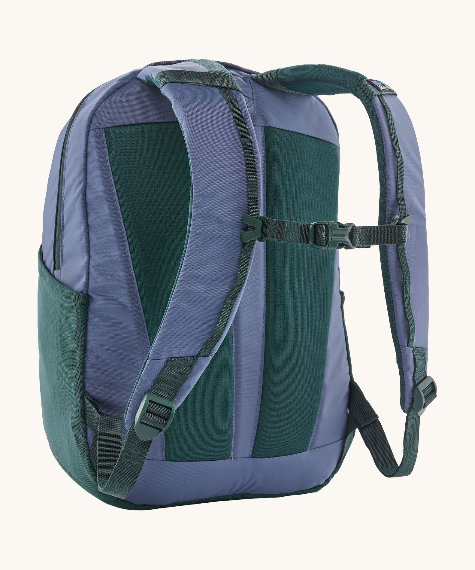 A reverse image of the Patagonia 24L current blue atom day pack in  showing the padded shoulder strap and dark green chest strap detail